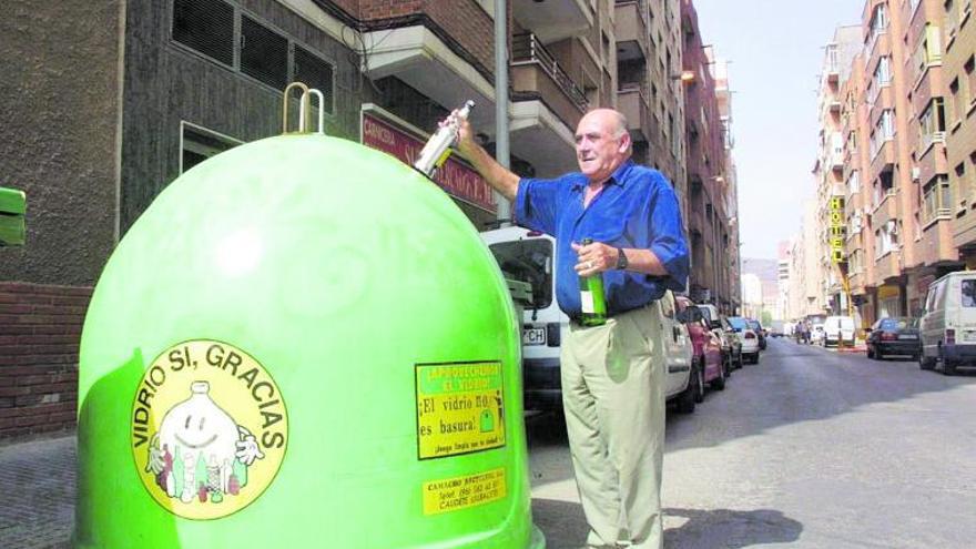 Un ciudadano recicla varios envases de vidrio. | L.O.