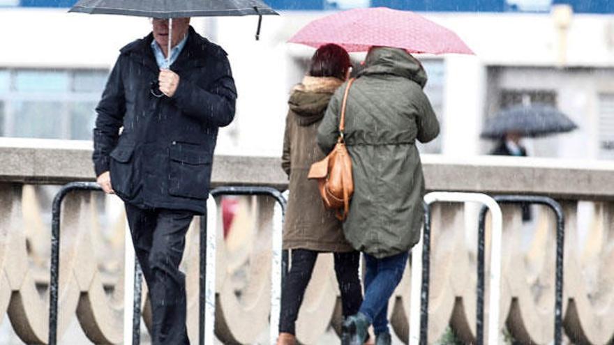 Varias personas con paraguas en A Coruña.