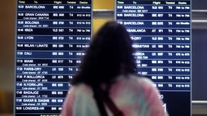 Una pasajera observa un cartel de vuelos en el aeropuerto de Madrid.