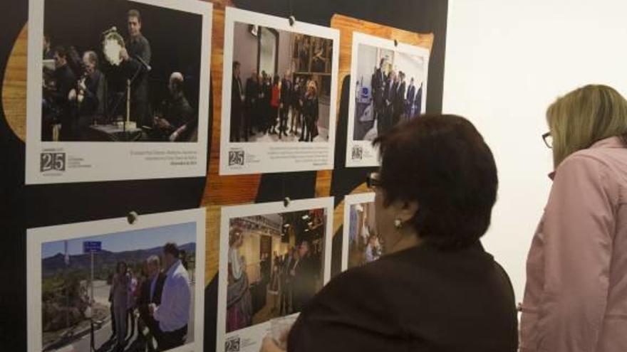 Visitantes, ante uno de los paneles de la exposición.