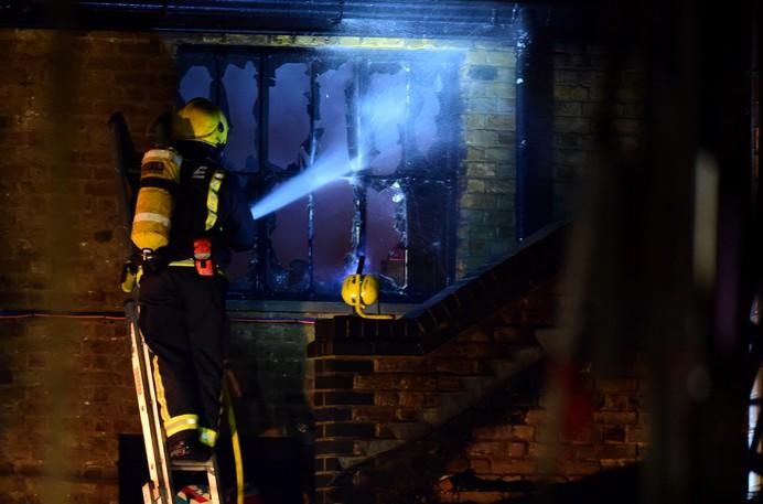 A firefighter tackles a fire at Camden Market in ...