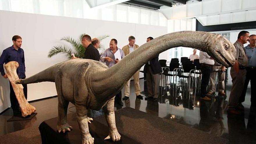 Imagen de la presentación de los restos fósiles hallados en Níger por los paleontólogos del MUPE y una recreación del dinosaurio