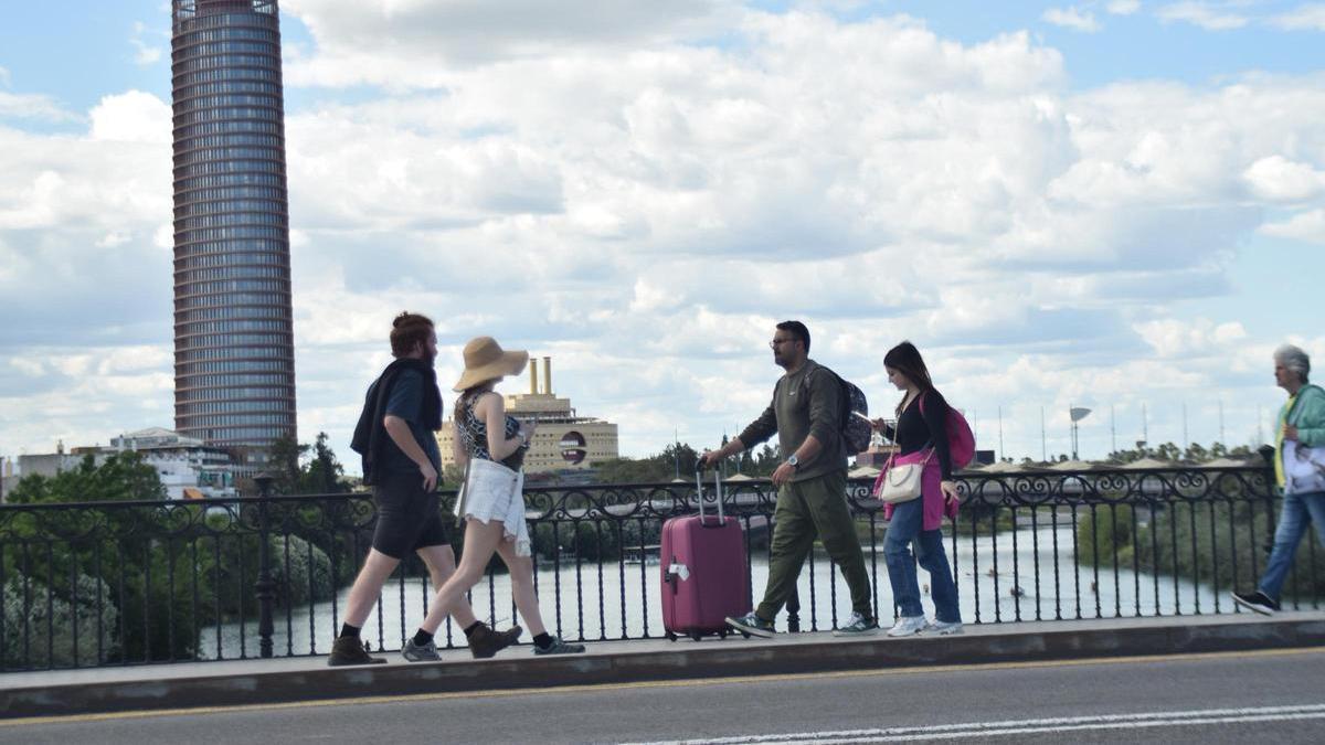 Turistas cruzando el puente de Triana