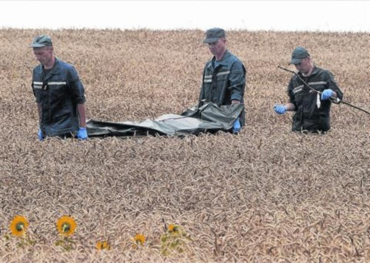 Mort als camps . El personal d’emergències trasllada el cadàver d’una víctima, ahir.