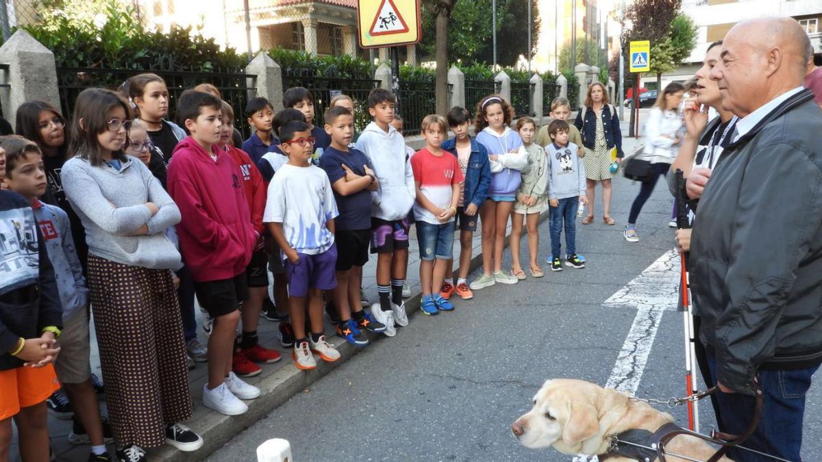 Julio Masid, con su perro guía Rico, explica a los alumnos cómo se mueve por la ciudad. |   // FERNANDO CASANOVA