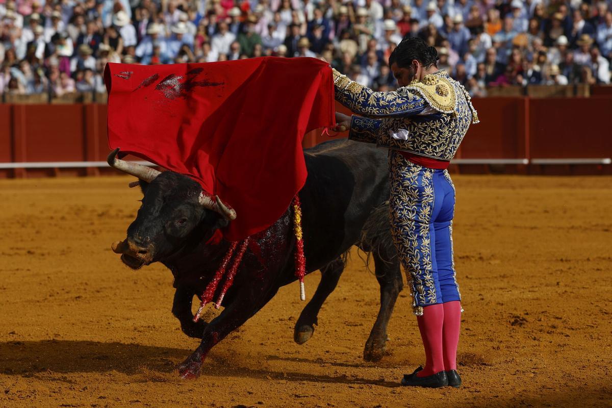 El diestro Morante de la Puebla da un pase durante la novena corrida de la Feria de Abril de Sevilla.