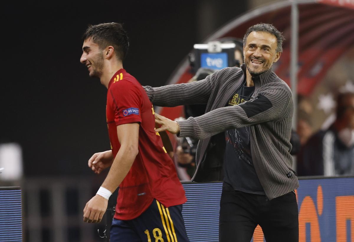 Ferran Torres bromea con Luis Enrique durante un partido con la selección española.