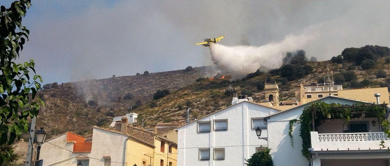 Un avión descarga sobre el frente de fuego que amenazaba Tollos.