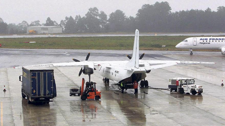 Un avión carga mercancías en el aeropuerto de Peinador, mientras otra aeronave de Air France se prepara para el despegue.  // J. Lores