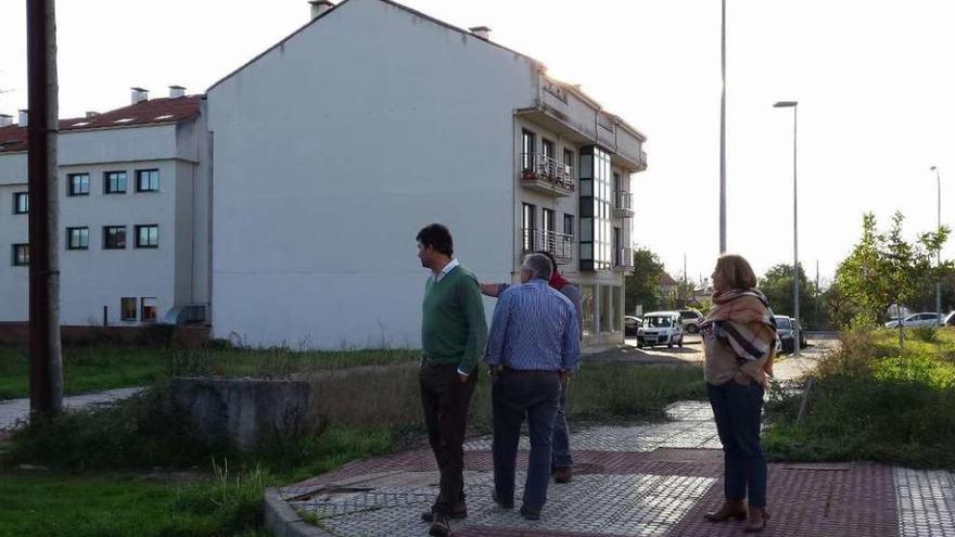 Nicolás González Casares y algunos vecinos en la urbanización sin terminar, ayer por la tarde.