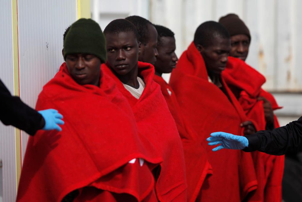 Migrant stand upon arriving on a rescue boat at ...