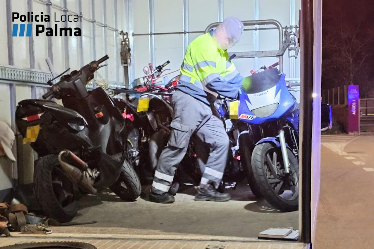 Un operario se lleva los ciclomotores retirados.