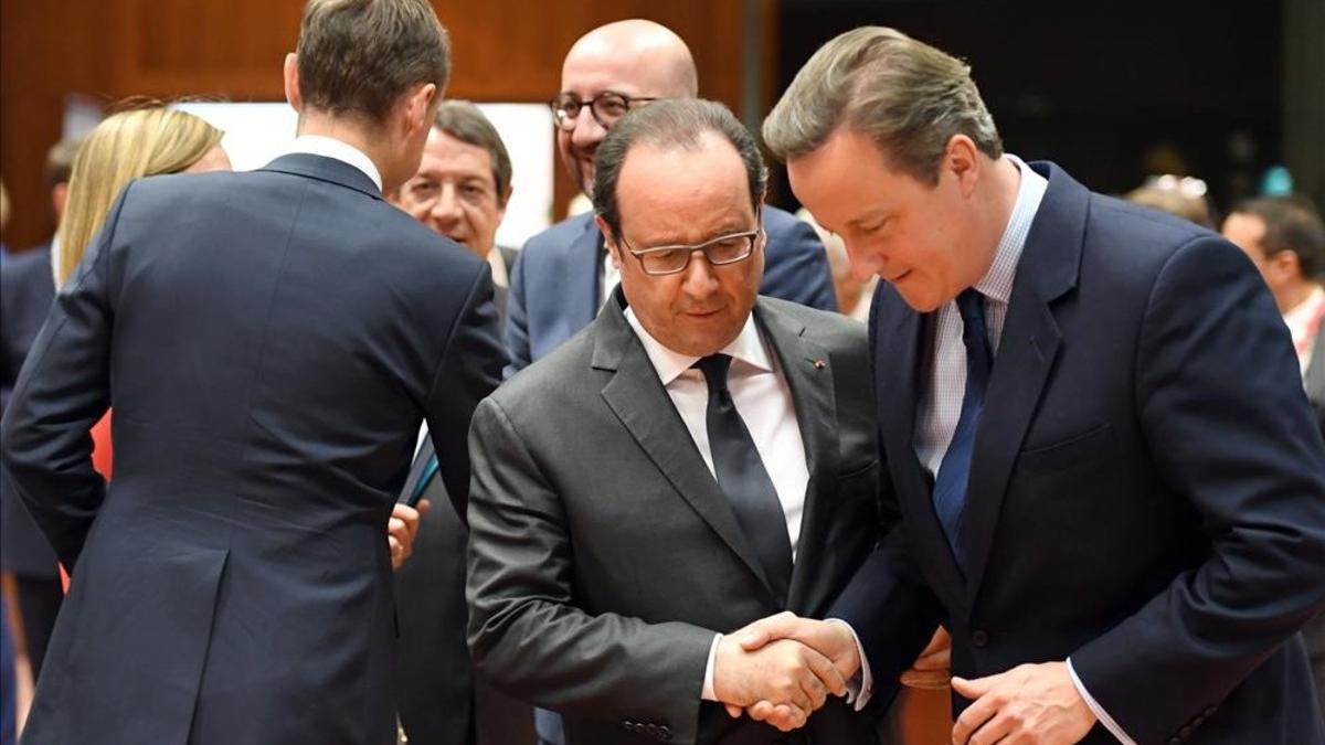 El primer ministro británico, David Cameron, y el presidente francés, François Hollande, conversan este martes antes del inicio de la cumbre europea.