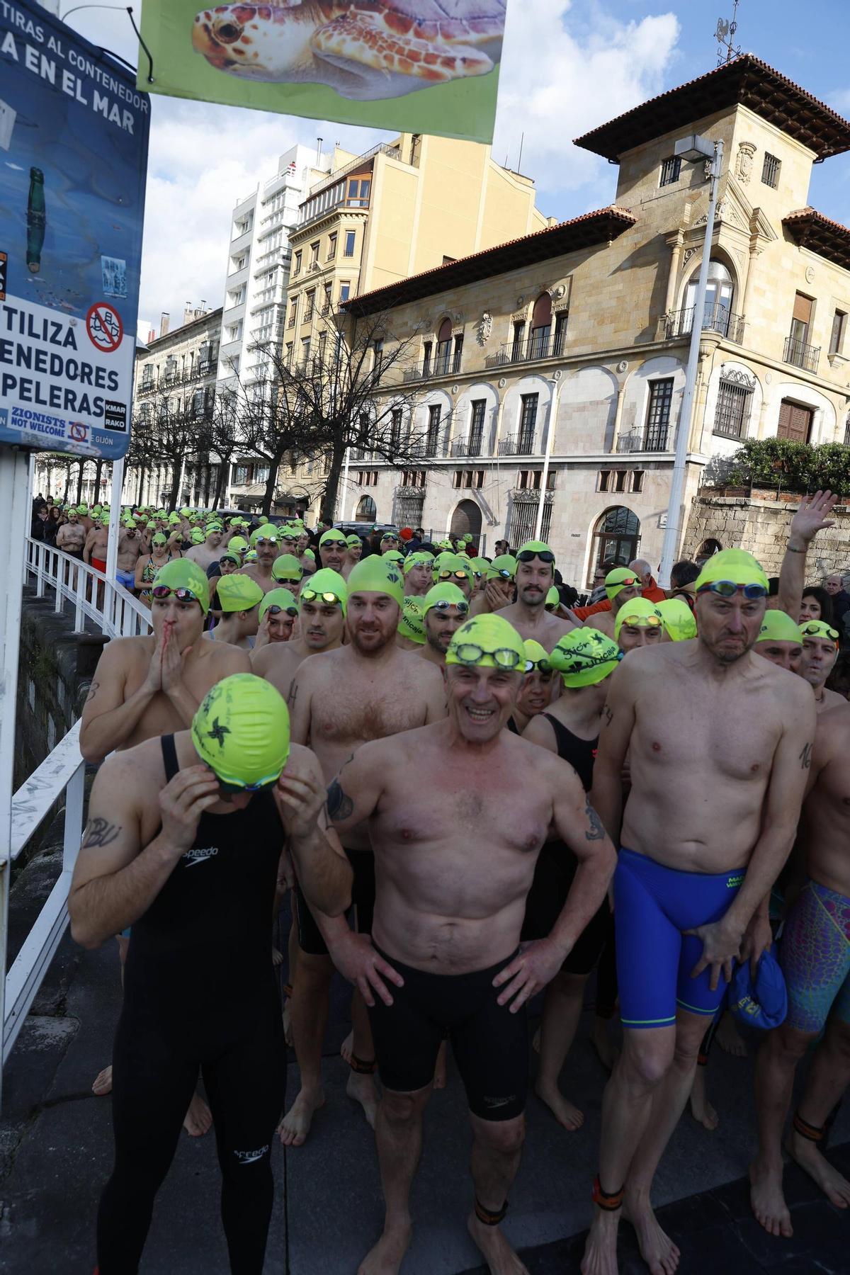 La travesía a nado de Navidad en Gijón congrega un año más a decenas de participantes (en imágenes)