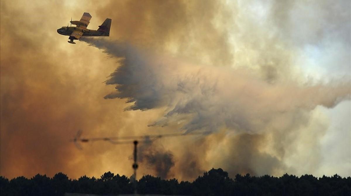 vvargas38968625 a fire fighting aircraft drops water over a fire outside the170619193523