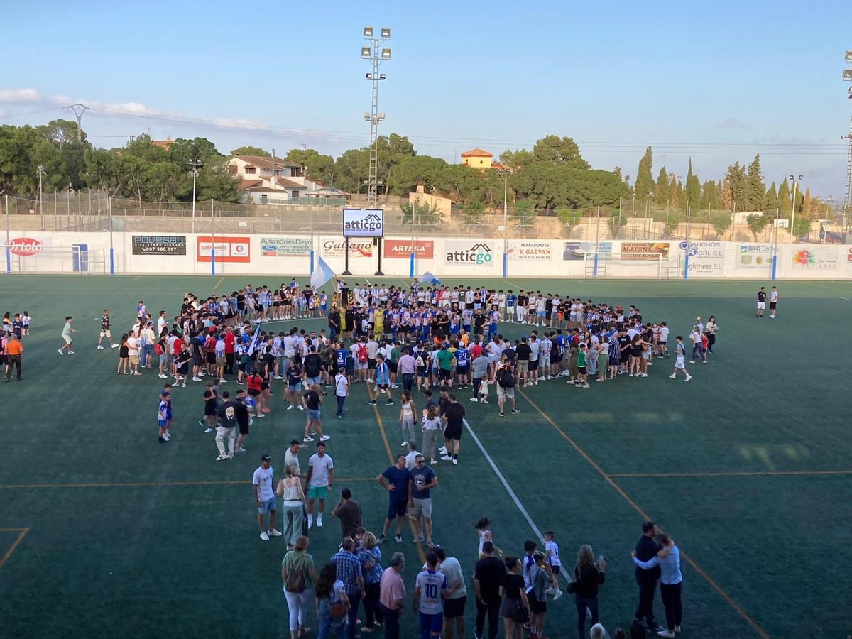 Los jugadores y la afición celebran el ascenso en centro del campo