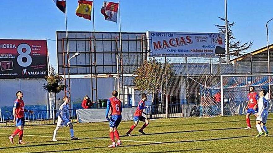 Los jugadores de ambos equipos esperan a que el esférico caiga del cielo empujado por el viento.