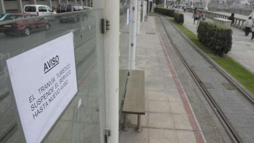 Un cartel, en una de las paradas del tranvía en el paseo marítimo, informa de la suspensión del servicio. / v. e.