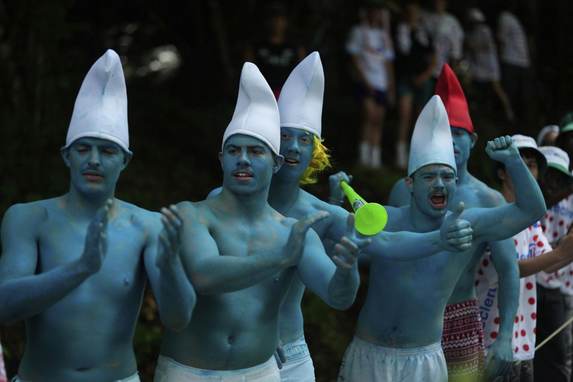 Five smurfs encourage the riders during the fifteenth stage of the Tour de France cycling race over 169.3 kilometers (105.2 miles) with start in Muret and finish in Carcassone, France, Sunday, July 20, 2025. (AP Photo/Mosa'ab Elshamy)