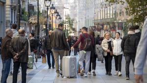 Turistas y compras pre navidad en los comercios del centro de Barcelona.