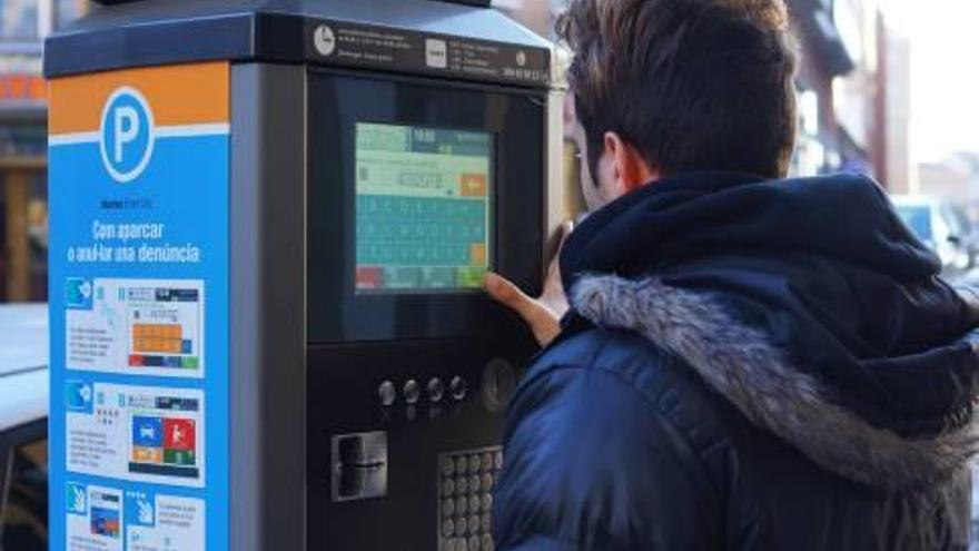 Un usuari de la zona blava fent servir el parquímetre