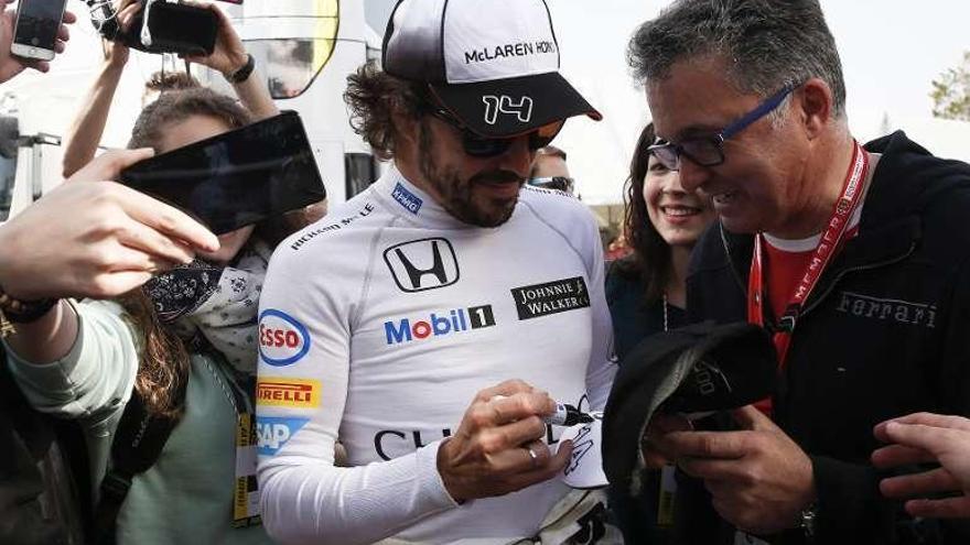 Fernando Alonso firma autógrafos ayer en Montmeló.