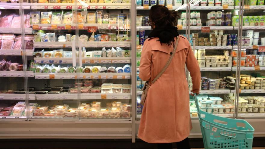 Una dona compara 
preus en un
supermercat.  ddg | DDG