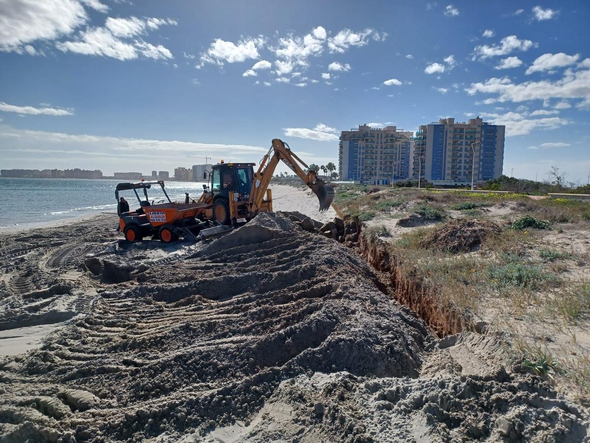 Pala excavadora trabajando en una duna de la Manga del Mar Menor