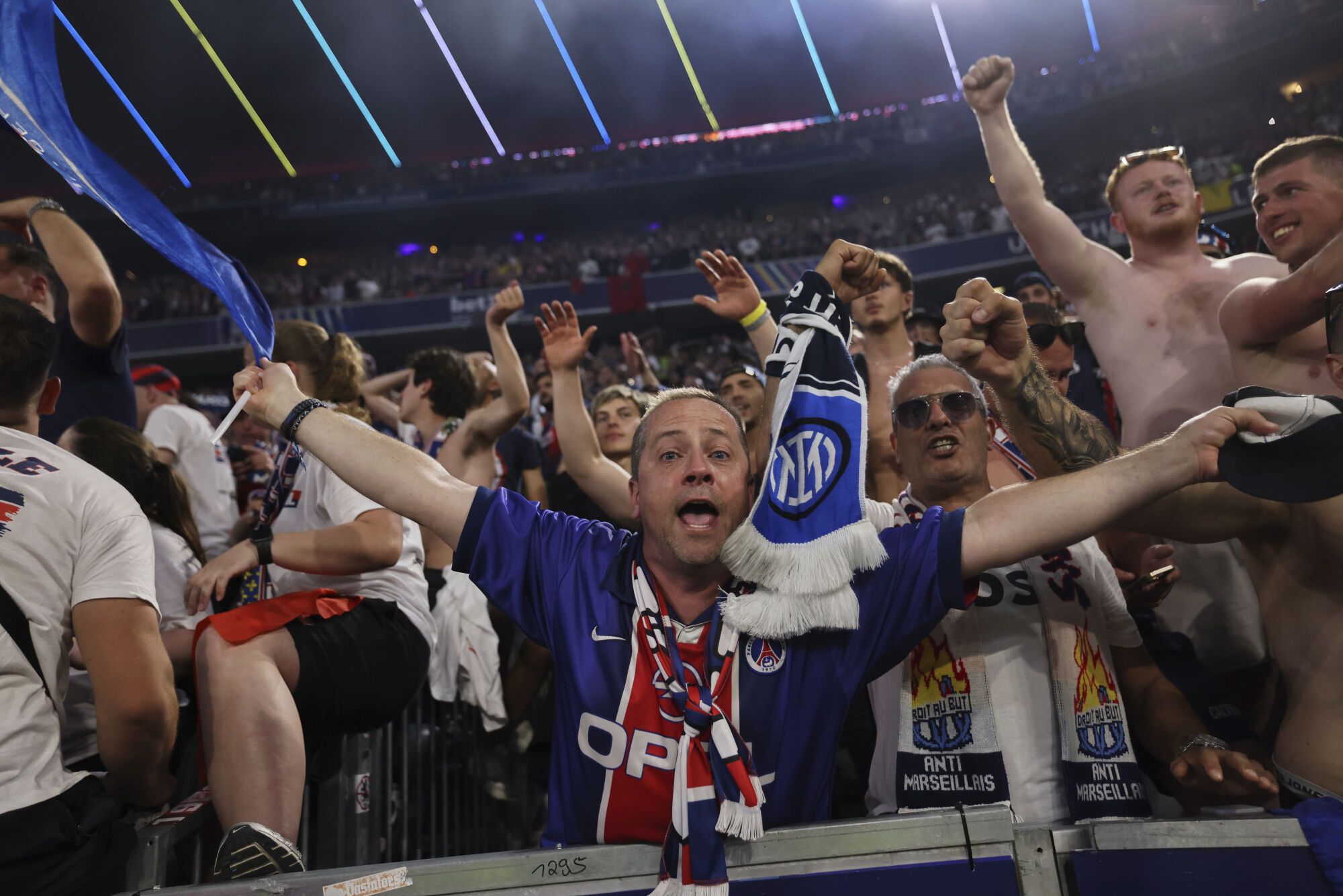 PSG fans celebrate during the Champions League final soccer match between Paris Saint-Germain and Inter Milan at the Allianz Arena in Munich, Germany, Saturday, May 31, 2025. (AP Photo/Alexandra Beier)