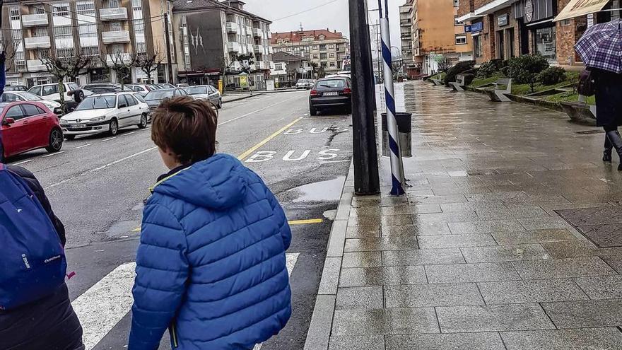 Señalización horizontal y vertical de parada del autobús en la calle Ourense de Tui. // E.G.
