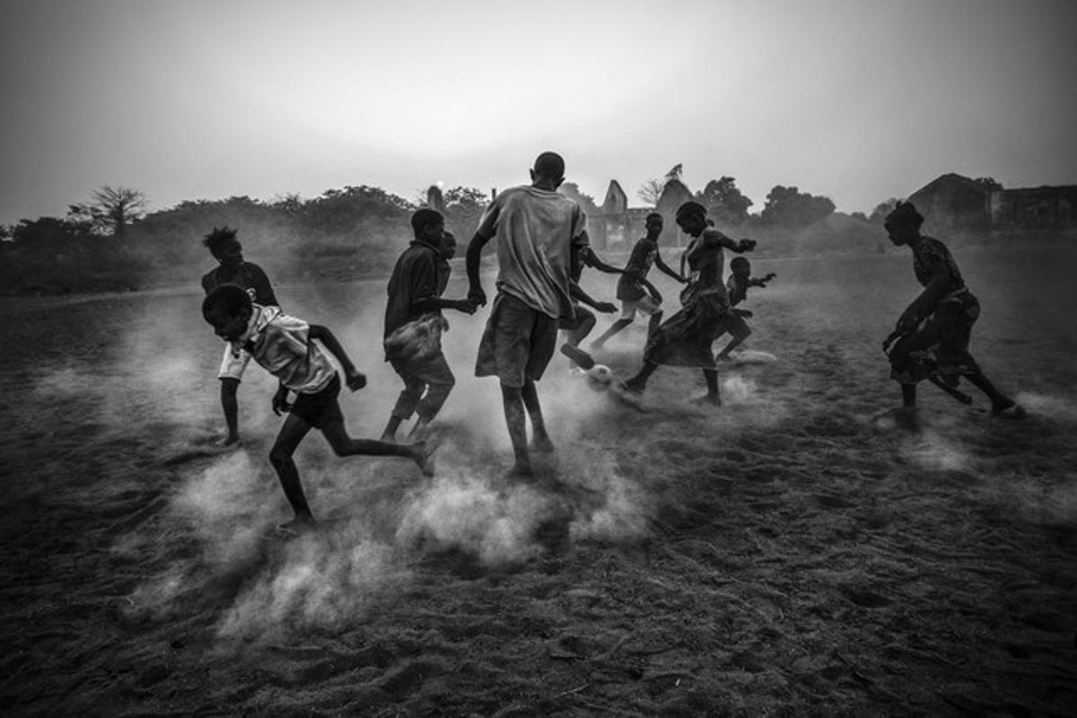 La fotografia guanyadora del primer premi en la categoria de vida quotidiana mostra un grup de joves jugant a futbol.