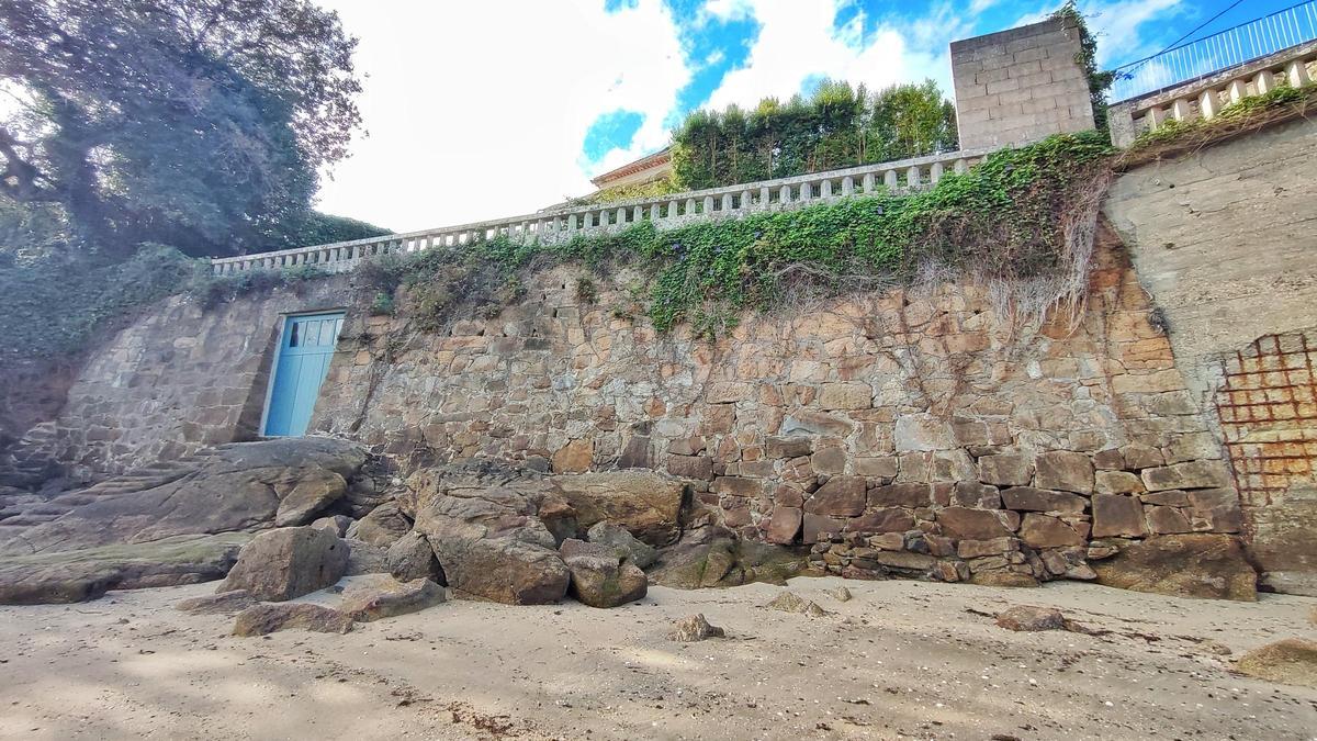 El muro, con el portal, que separa el terreno anexo al chalé de Eva Cárdenas de la playa de O Con.