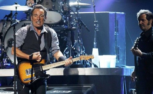 Singer Bruce Springsteen performs along with bassist Garry Tallent during the "12-12-12" benefit concert for victims of Superstorm Sandy at Madison Square Garden in New York