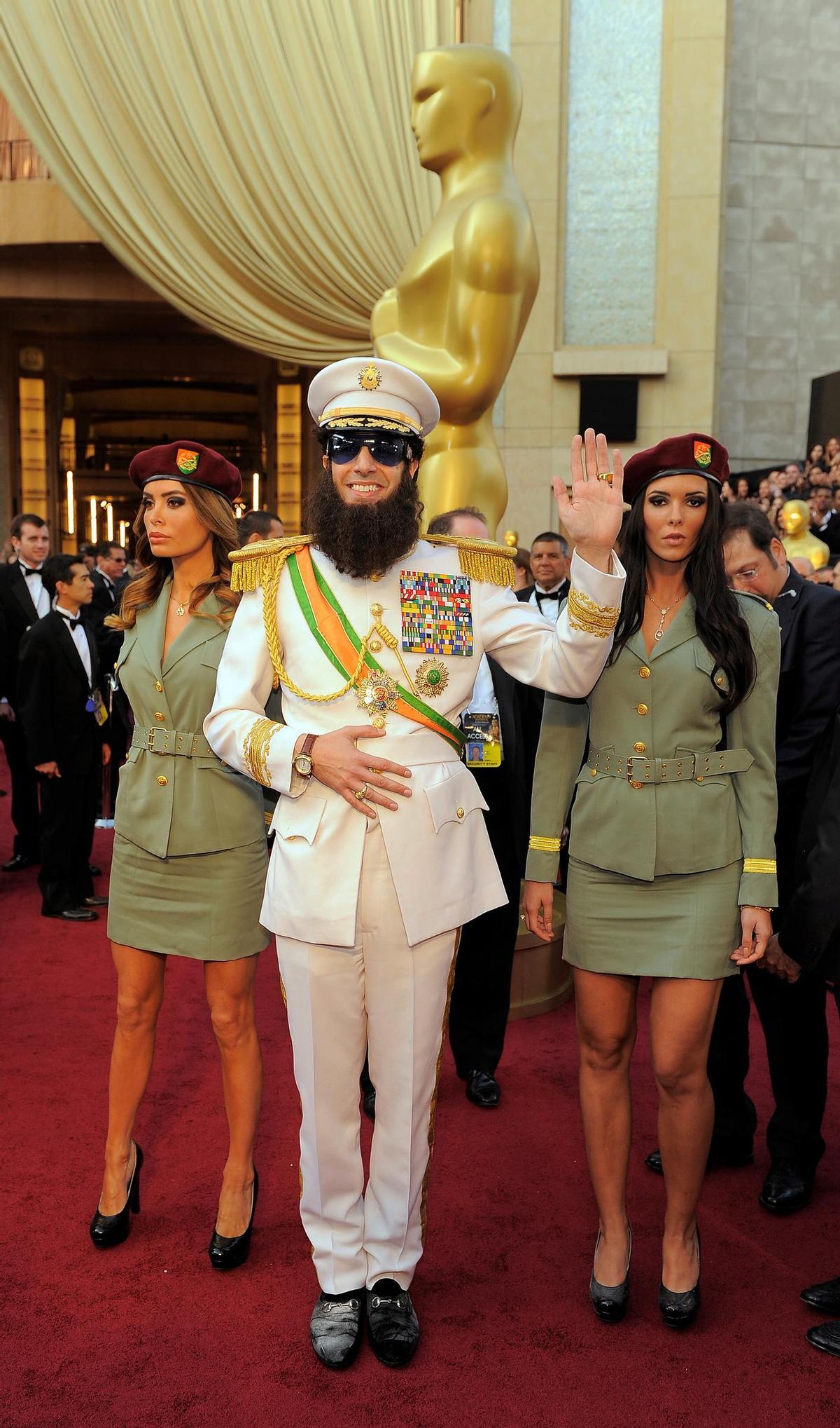 Sacha Baron Cohen, center, and guests arrive before the 84th Academy Awards on Sunday, Feb. 26, 2012, in the Hollywood section of Los Angeles. (AP Photo/Chris Pizzello)