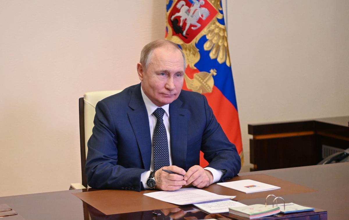 Vladimir Putin attends a ceremony of raising the national flag on the 'Marshal Rokossovsky' ferry in northern Russia