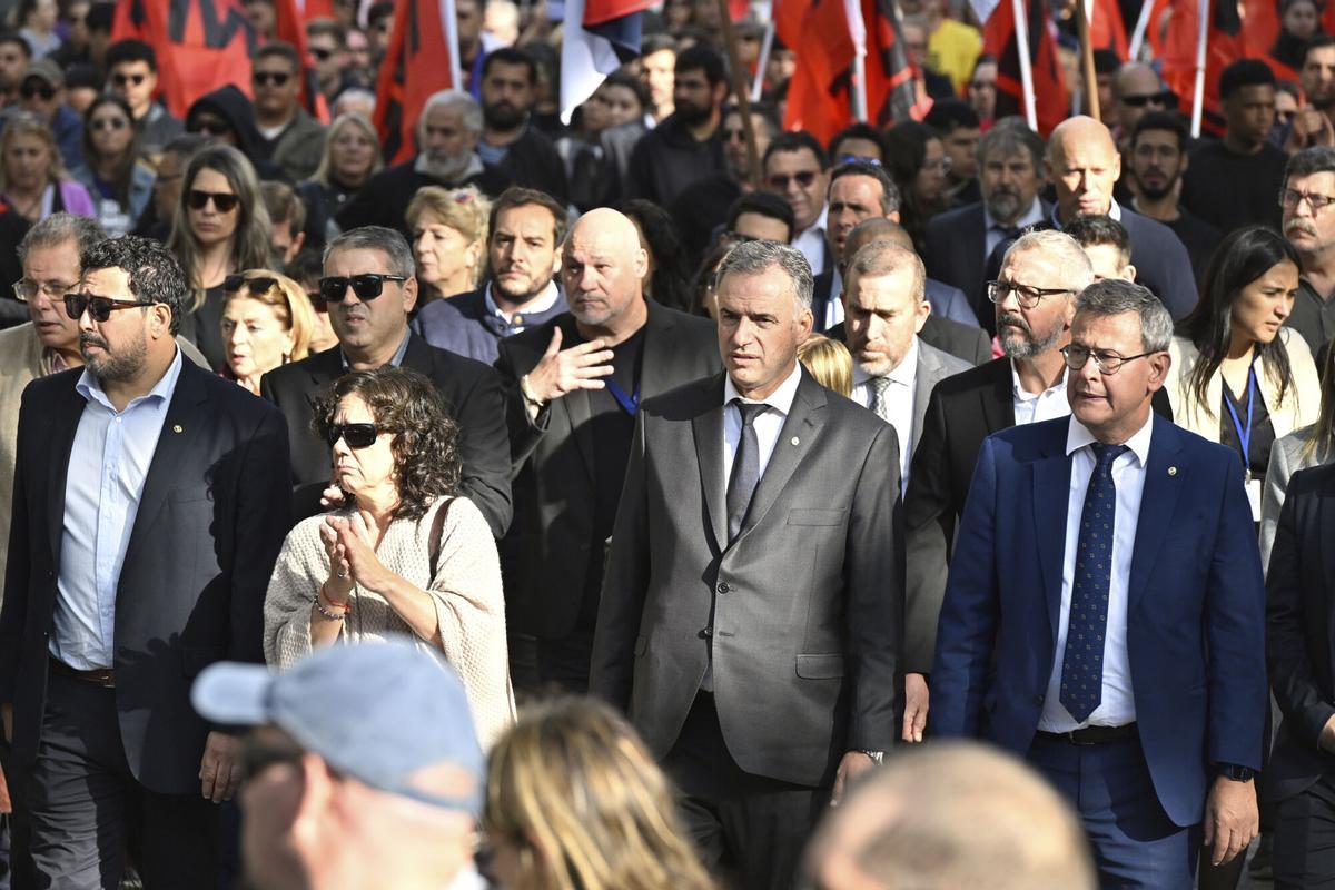 Uruguayan President Yamandu Orsi, second from right, front, leads the funeral procession for late former President Jose Mujica in Montevideo, Uruguay, Wednesday, May 14, 2025. (AP Photo/Santiago Mazzarovich)