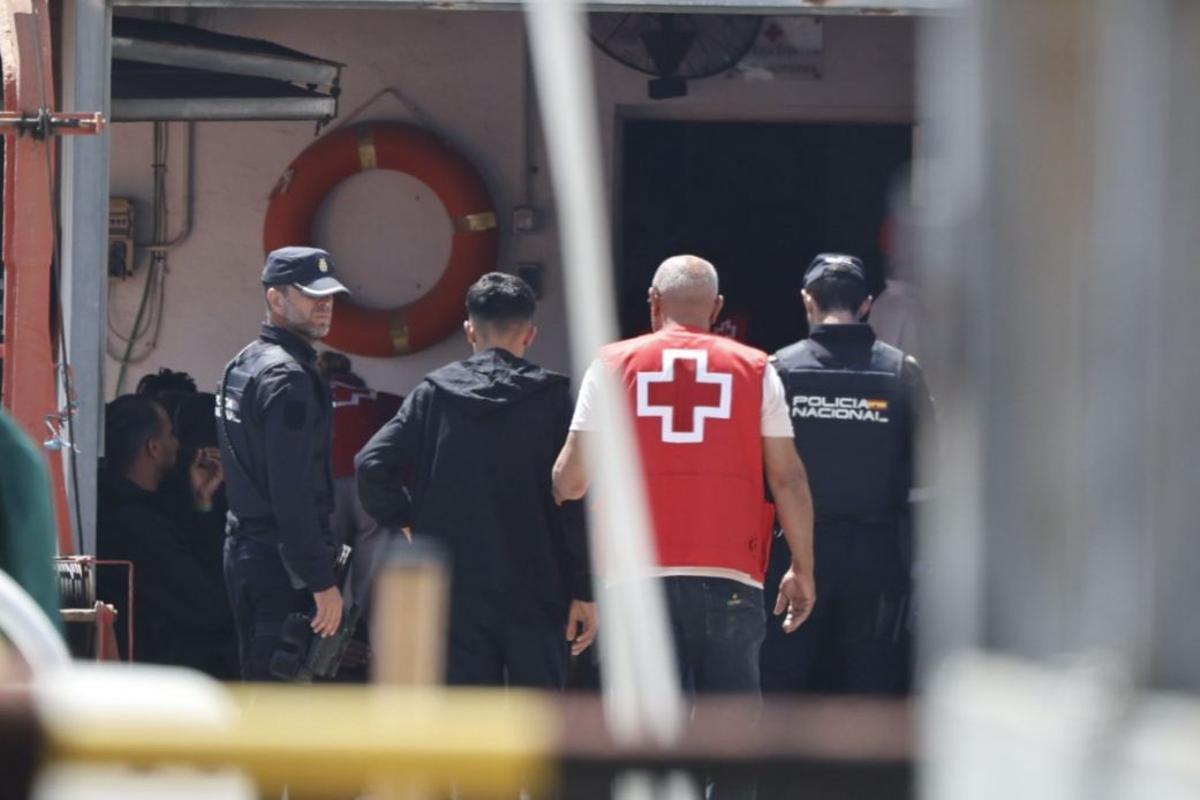 Efectivos de Cruz Roja y Policía Nacional atienden a los llegados en patera, este miércoles