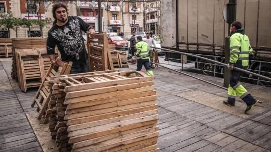 Operarios descargando ayer las sillas que se van a instalar en el recorrido de las Entradas.