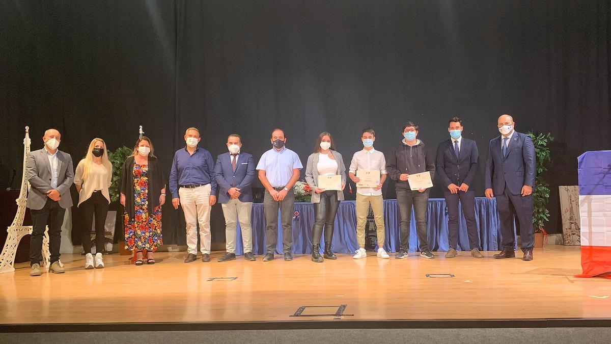 Los tres alumnos premiados, junto a las autoridades.