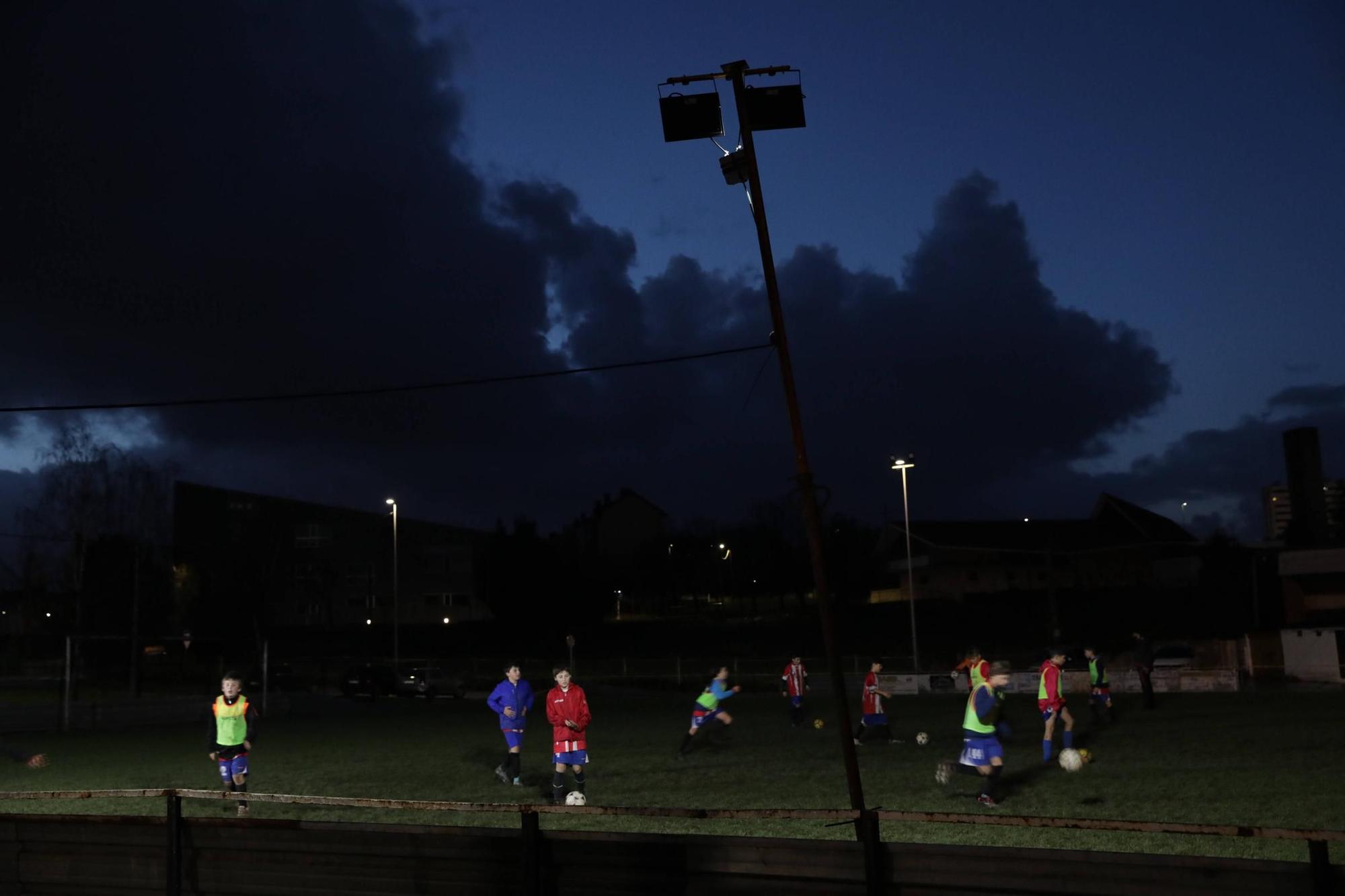 Condenados a jugar al fútbol casi a oscuras en Gijón (en imágenes)