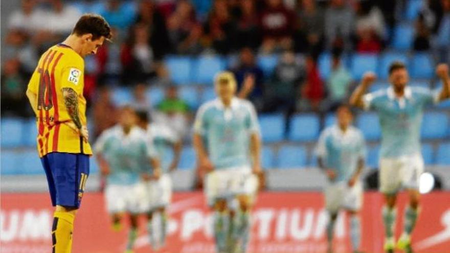 Messi, capjup, mentre els jugadors del Celta al fons celebren un gol.