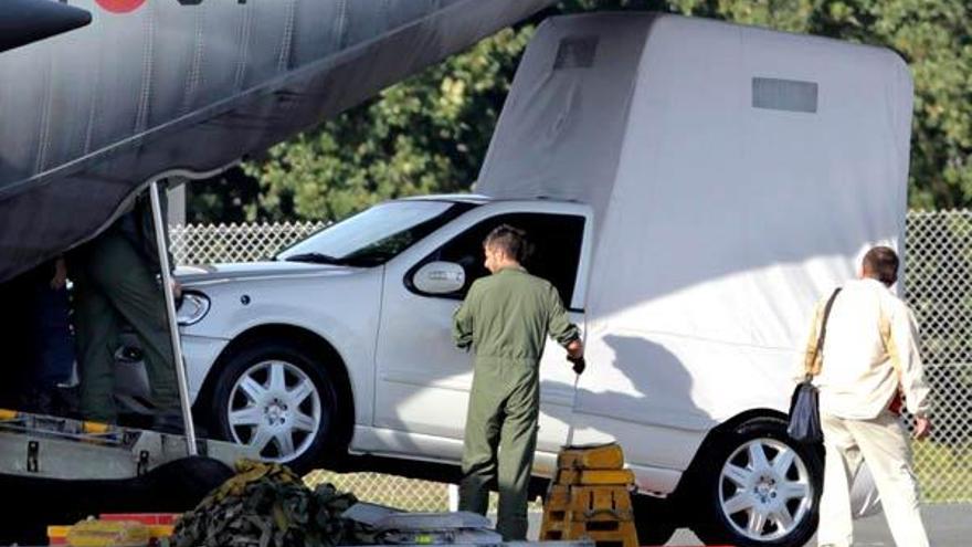 Varias personas observan descender el papamóvil del avión del Ejército Español que lo ha trasladado desde Roma hasta el aeropuerto de Lavacolla, en Santiago de Compostela, donde continúan los preparativos para visita de Benedicto XVI, el próximo seis de noviembre. // EFE