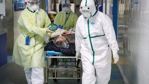 Medical workers in protective suits move a patient at an isolated ward of a hospital in Caidian district following an outbreak of the novel coronavirus in Wuhan, Hubei province, China February 6, 2020. Picture taken February 6, 2020. China Daily via REUTERS  ATTENTION EDITORS - THIS IMAGE WAS PROVIDED BY A THIRD PARTY. CHINA OUT.