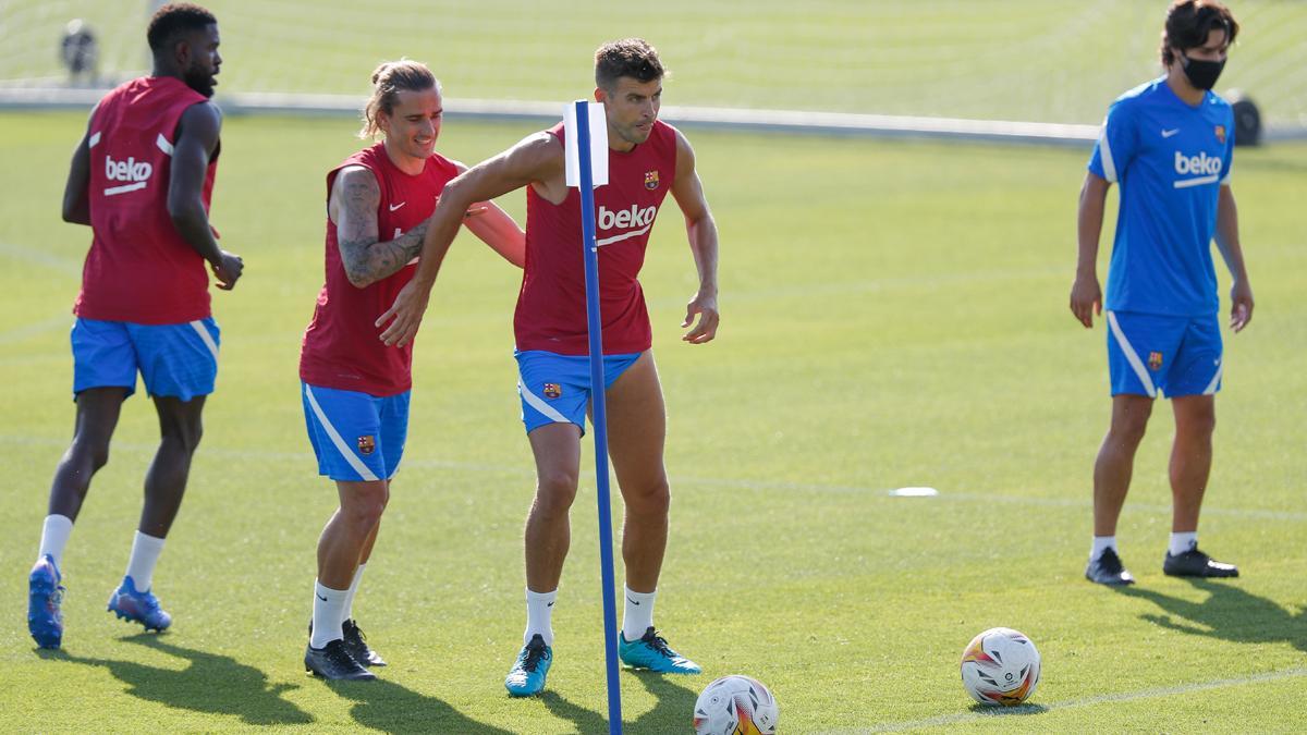 Griezmann y Piqué bromean durante un entrenamiento de pretemporada