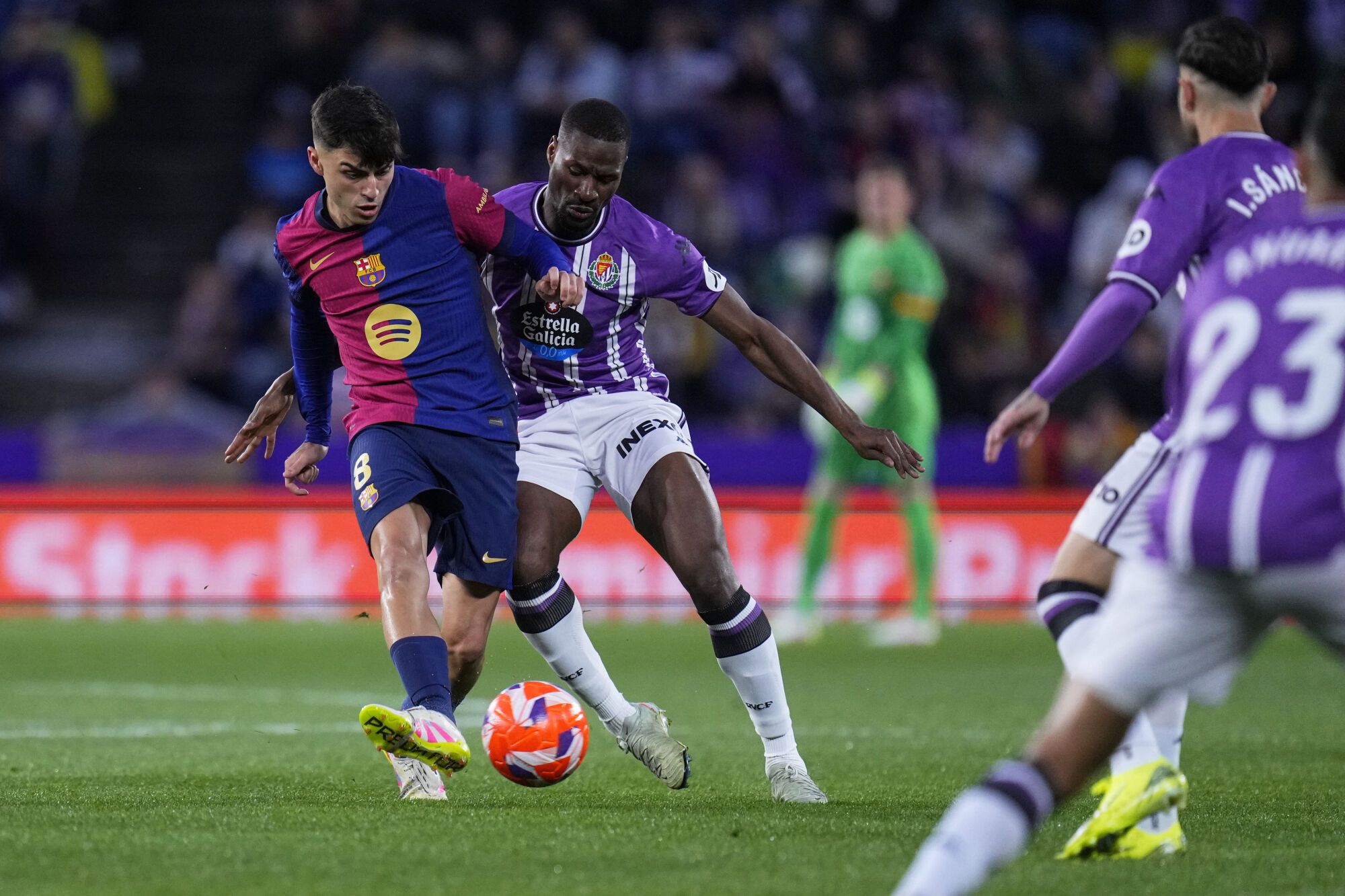 Barcelona's Pedri, left, and Valladolid's Mamadou Sylla challenge for the ball during the Spanish La Liga soccer match between Valladolid and FC Barcelona at the Jose Zorrilla stadium in Valladolid, Spain, Saturday, May 3, 2025. (AP Photo/Manu Fernandez). EDITORIAL USE ONLY/ONLY ITALY AND SPAIN