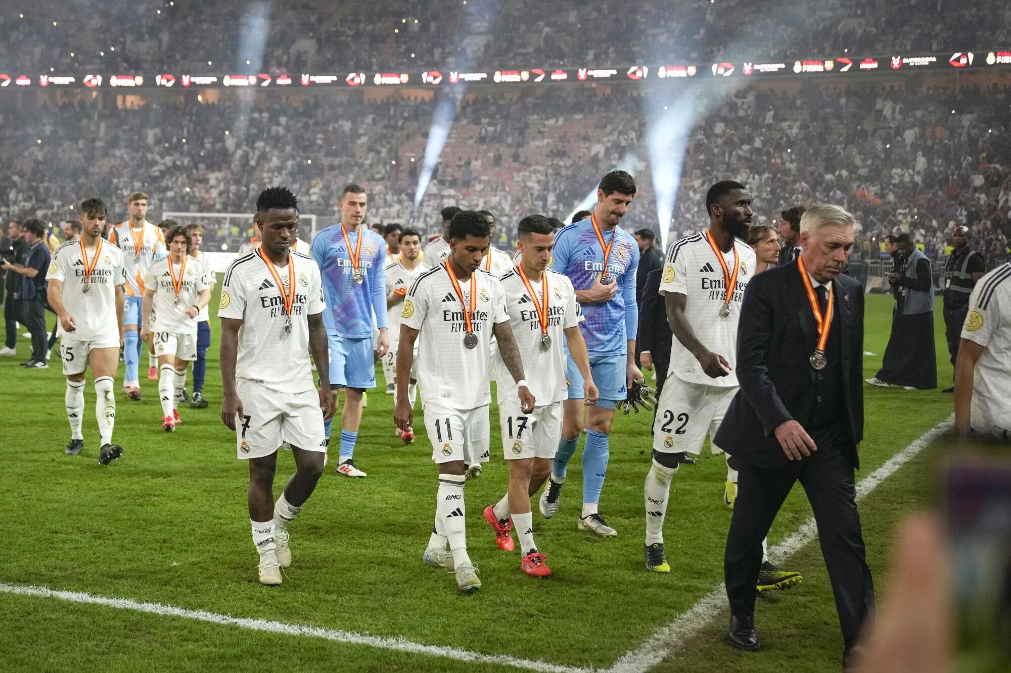 Real Madrid players leave the pitch after the final soccer match between Real Madrid and Barcelona at King Abdullah Stadium in Jeddah, Saudi Arabia, Monday, Jan. 13, 2025. (AP Photo/Altaf Qadri)