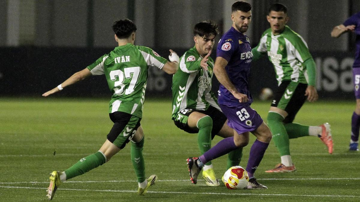 Josep Calavera protege el balón rodeado de futbolistas del Betis B.