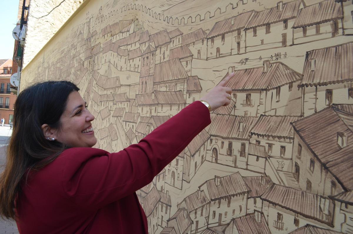 La alcaldesa observa uno de los detalles del mural, en el que se observa el toro enmaromado.