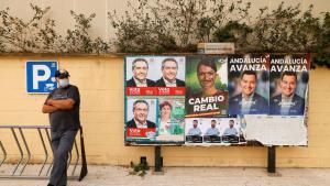 Un hombre frente a unos carteles electorales de las elecciones en Andalucía, en Mairena de Aljarafe, Sevilla.