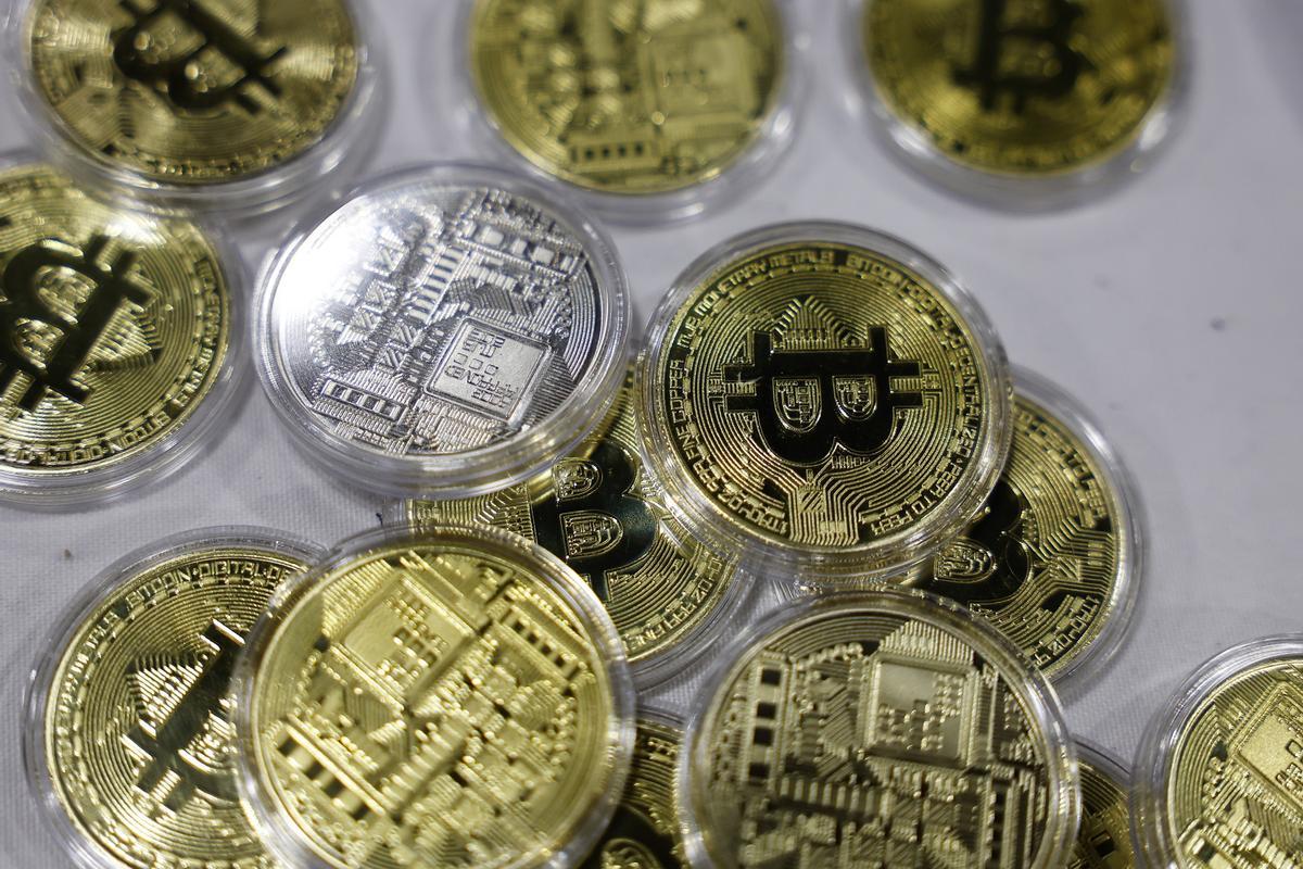 Logo del bitcoin en varias monedas de oro.